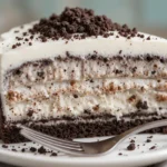 Slice of Oreo ice cream cake recipe served on a plate with visible layers