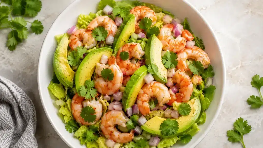 Shrimp Avocado Salad with avocado, lettuce, red onion, cilantro, and lime