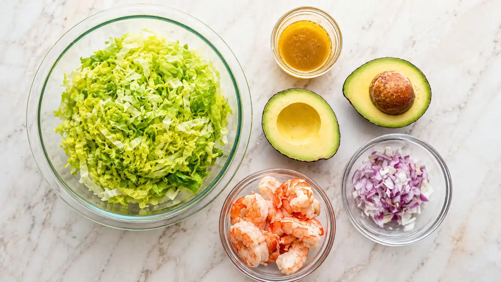 Shrimp Avocado Salad ingredients with shrimp avocado lettuce lime and cilantro